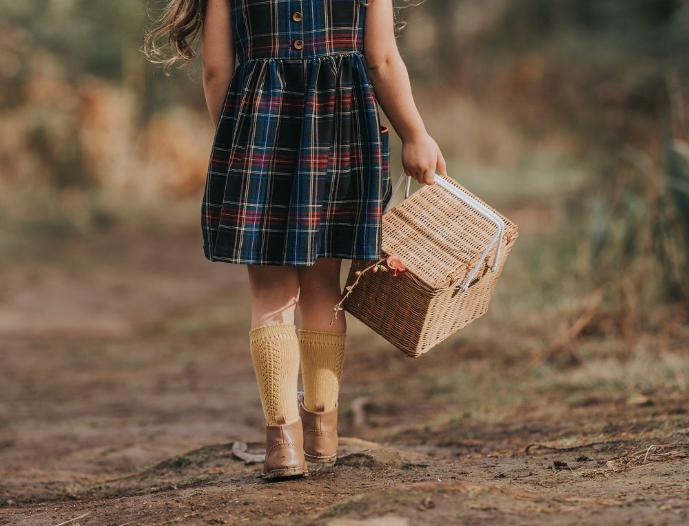 Child carrying Olli Ella Basket on an outdoor nature trail adventure at Oskar's Wooden Ark in Australia