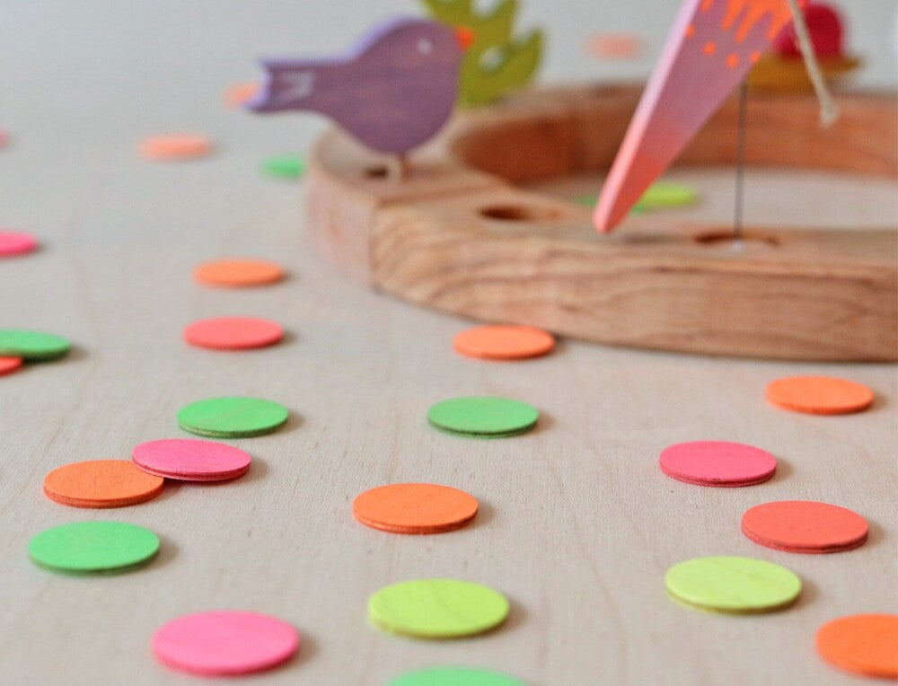 Brightly Coloured Wooden Confetti Dots decorating the party table for a child's Birthday celebration, available in Australia from Oskar's Wooden Ark