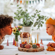 Children blowing out candles - Waldorf Birthday celebration with celebration ring, candles and decorative items from Grimm's Wooden Toys, Available in Australia from Oskar's Wooden Ark