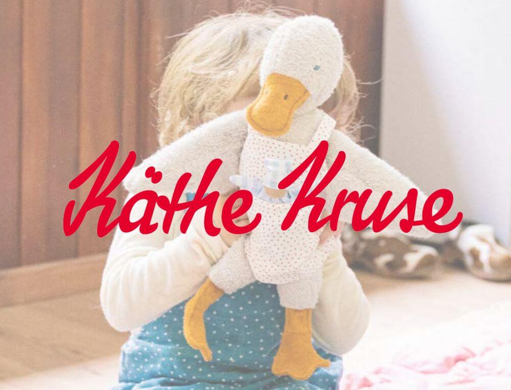 Child with handcrafted Kathe Kruse cuddly duck toy from Oskar's Wooden Ark in Australia