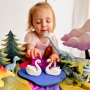Young girls creating an imaginary small play world with handcrafted wooden animal figures, tress and landscapes - Available in Australia from Oskar's Wooden Ark