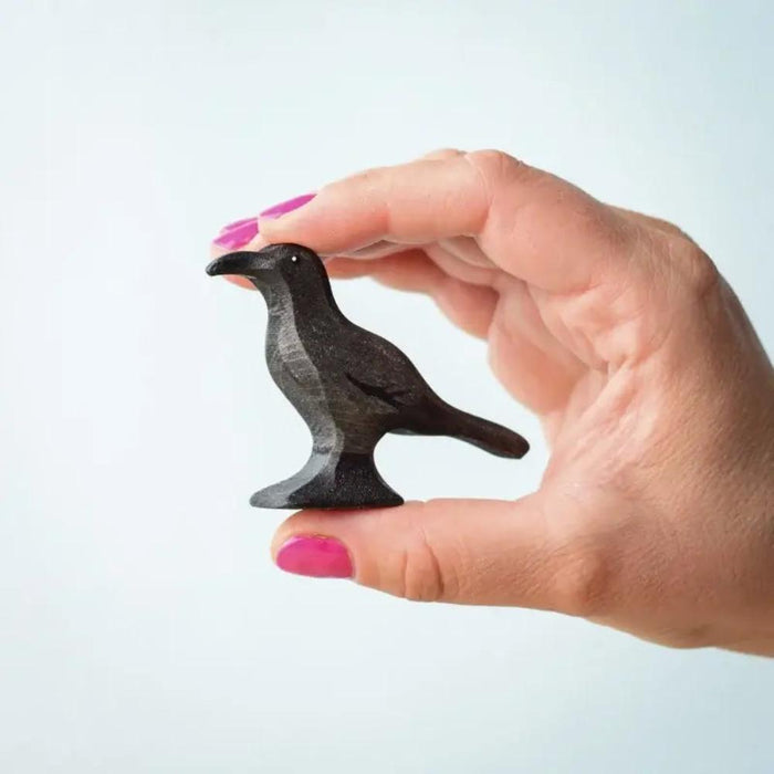 BumbuToys Wooden Bird Figurine from Halloween Collection - Black Raven in Adult Hand for Size Comparison