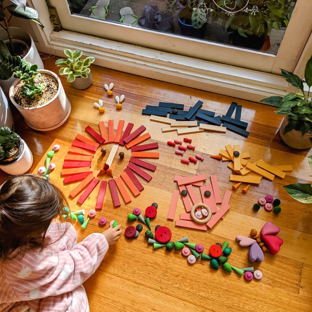 Child creating loose parts artworks with KAPLA wooden building planks from Oskar's Wooden Ark in Australia 