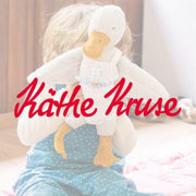 Child with handcrafted Kathe Kruse cuddly duck toy from Oskar's Wooden Ark in Australia