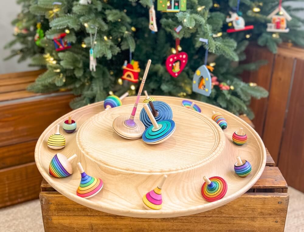 Mader spinning tops in front of Christmas tree at Oskar's Wooden Ark in Australia