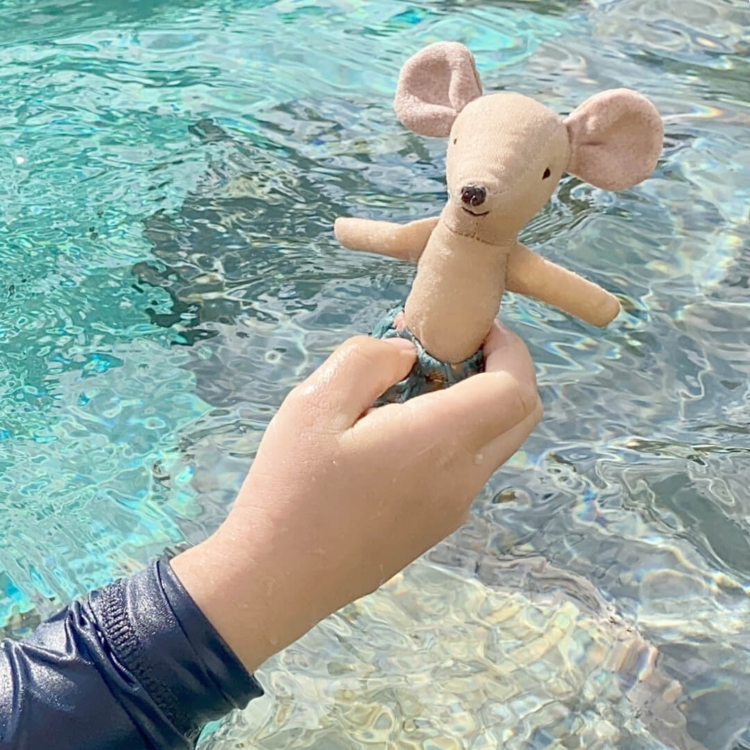 Child swimming with Maileg mouse at Oskar's Wooden Ark in Australia