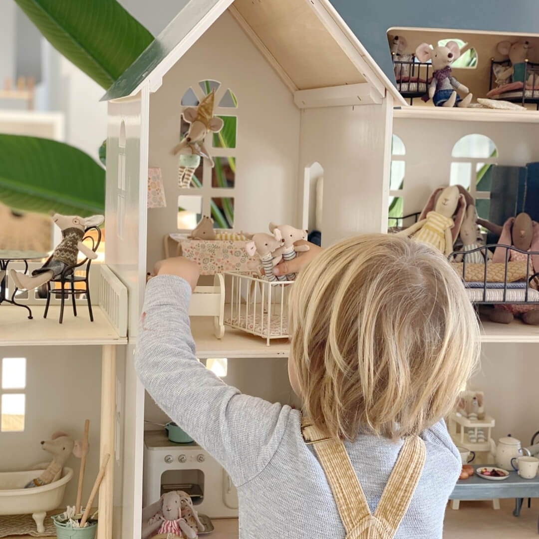 Child playing with Maileg Mice and Rabbits in beautiful dolls' house with furniture and accessories at Oskar's Wooden Ark in Australia