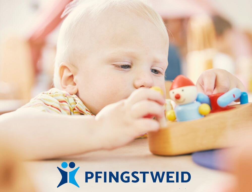 Toddler playing with Pfingsweid Wooden Vehicle toy from Oskar's Wooden Ark in Australia