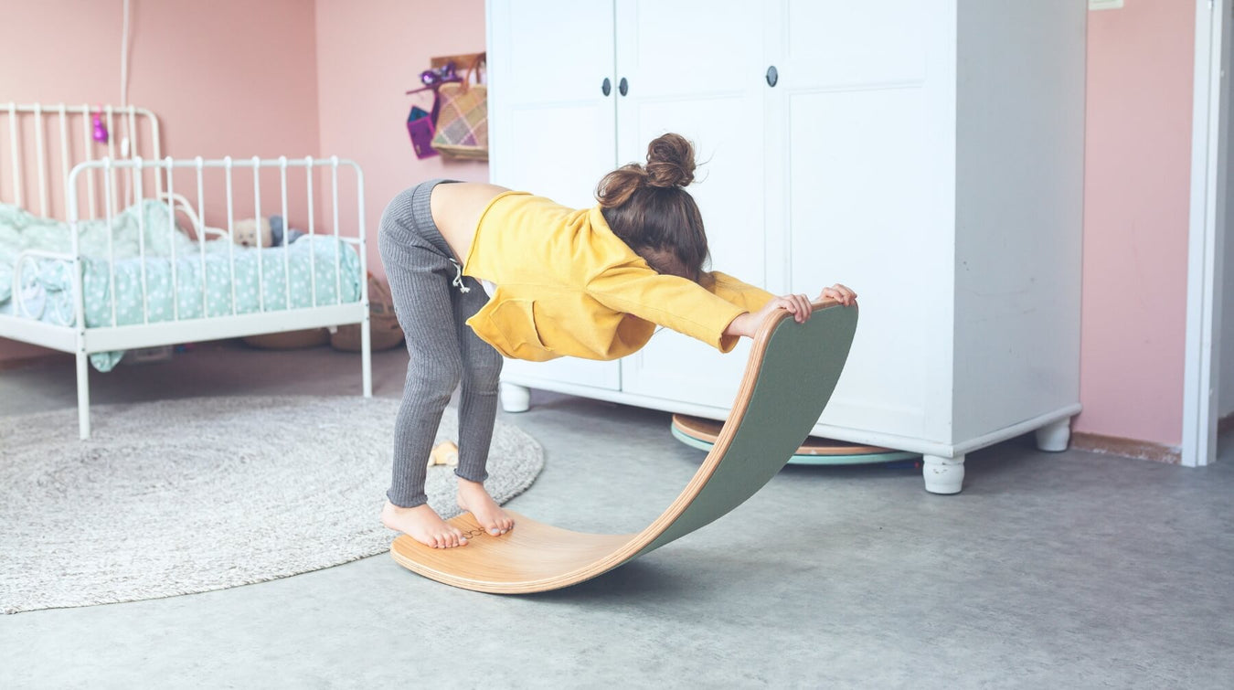 Child enjoying indoor active play on Wobbel Balance Board at Oskar's Wooden Ark in Australia