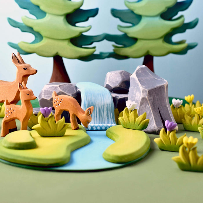 BumbuToys Handcrafted Wooden Animal Grazing Deer Fawn from Australia in a small-world play setting
