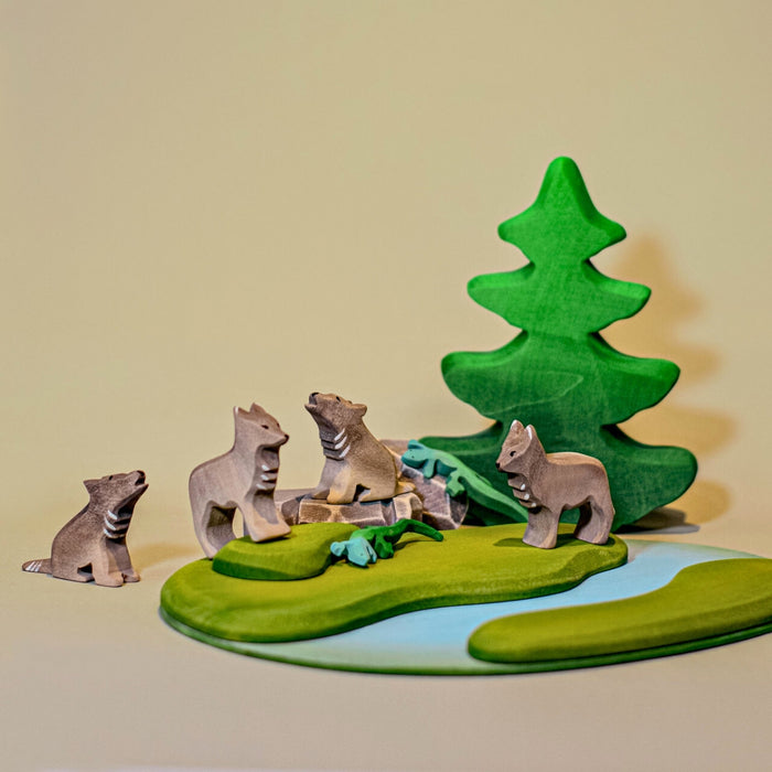 BumbuToys Handcrafted Wooden Animal Wolf Cub Sitting and Howling from Australia in a small-world play setting