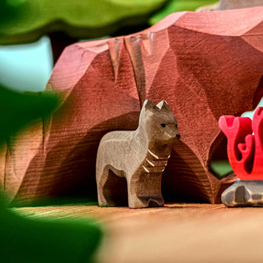 BumbuToys Handcrafted Wooden Animal Wolf Cub from Australia in a small-world play setting