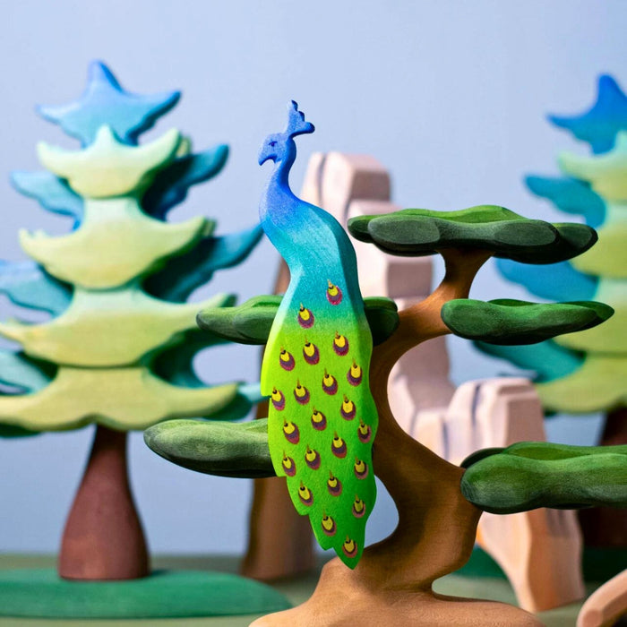 BumbuToys Handcrafted Wooden Bird Peacock from Australia in a small-world play setting