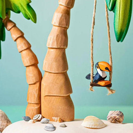 BumbuToys Handcrafted Wooden Bird Baby Toucan from Australia in a small-world play setting