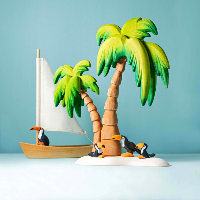 BumbuToys Handcrafted Wooden Bird Toucan Standing from Australia in a small-world play setting