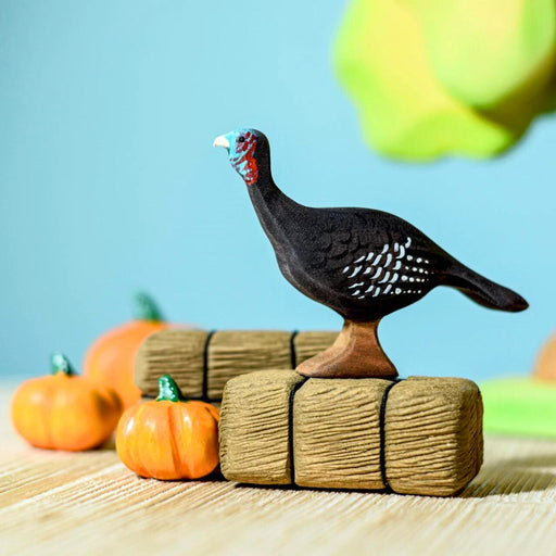 BumbuToys Handcrafted Wooden Bird Turkey Hen from Australia in a small-world farm play setting