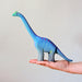 BumbuToys Handcrafted Wooden Dinosaur Brontosaurus Big from Australia on an adult person's palm