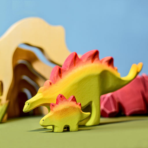 BumbuToys Handcrafted Wooden Dinosaur Stegosaurus Set Big and Baby from Australia in a small-world play setting