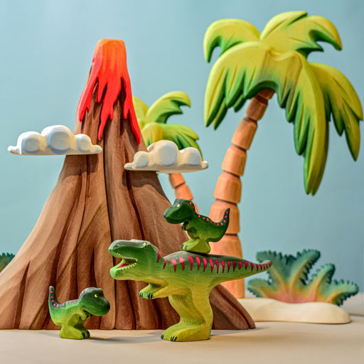 BumbuToys Handcrafted Wooden Dinosaur T-Rex Family from Australia in a small-world play setting