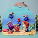 BumbuToys Handcrafted Wooden Baby Dolphin from Australia in a small-world play setting