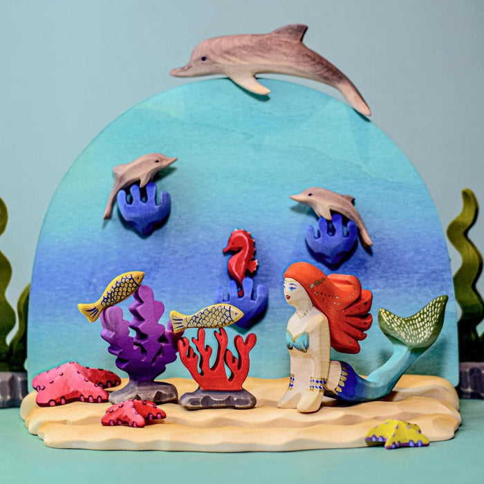 BumbuToys Handcrafted Wooden Dolphins Set from Australia in a small-world play setting