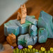 BumbuToys Handcrafted Wooden Landscape Mossy Rocks Set of 5 from Australia in a small-world play setting
