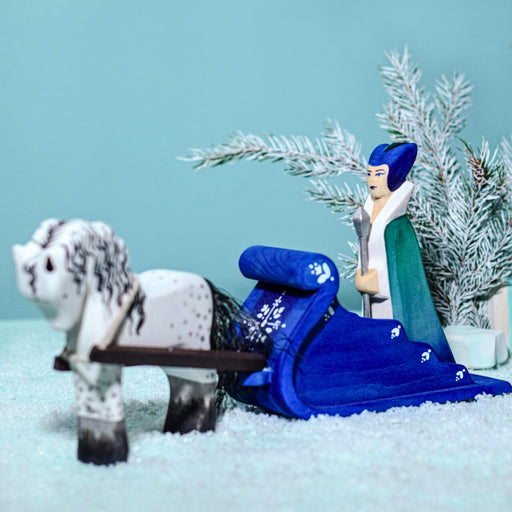 BumbuToys Handcrafted Wooden Snow Queen Figure, Sleigh, and White Horse Set from Australia in a small-world play setting