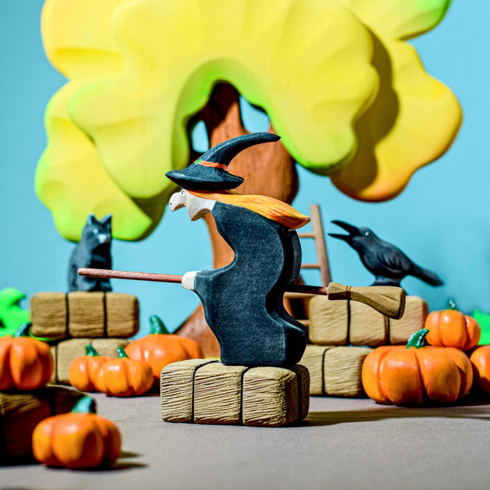 BumbuToys Handcrafted Wooden Witch Figure from Australia in a small-world play setting