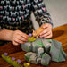 BumbuToys Handcrafted Wooden Plant Figure Small Grass with Lilac Flower from Australia in a small-world play setting
