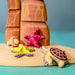 BumbuToys Handcrafted Wooden Starfish Set in Yellow from Australia in a small-world play setting