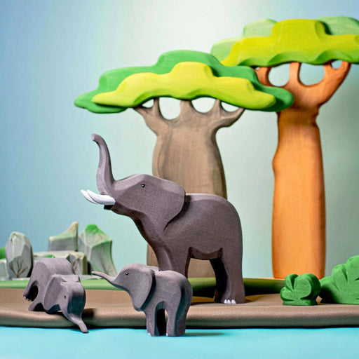 BumbuToys Handcrafted Wooden Tree Baobabs Set of 2 from Australia in a small-world play setting