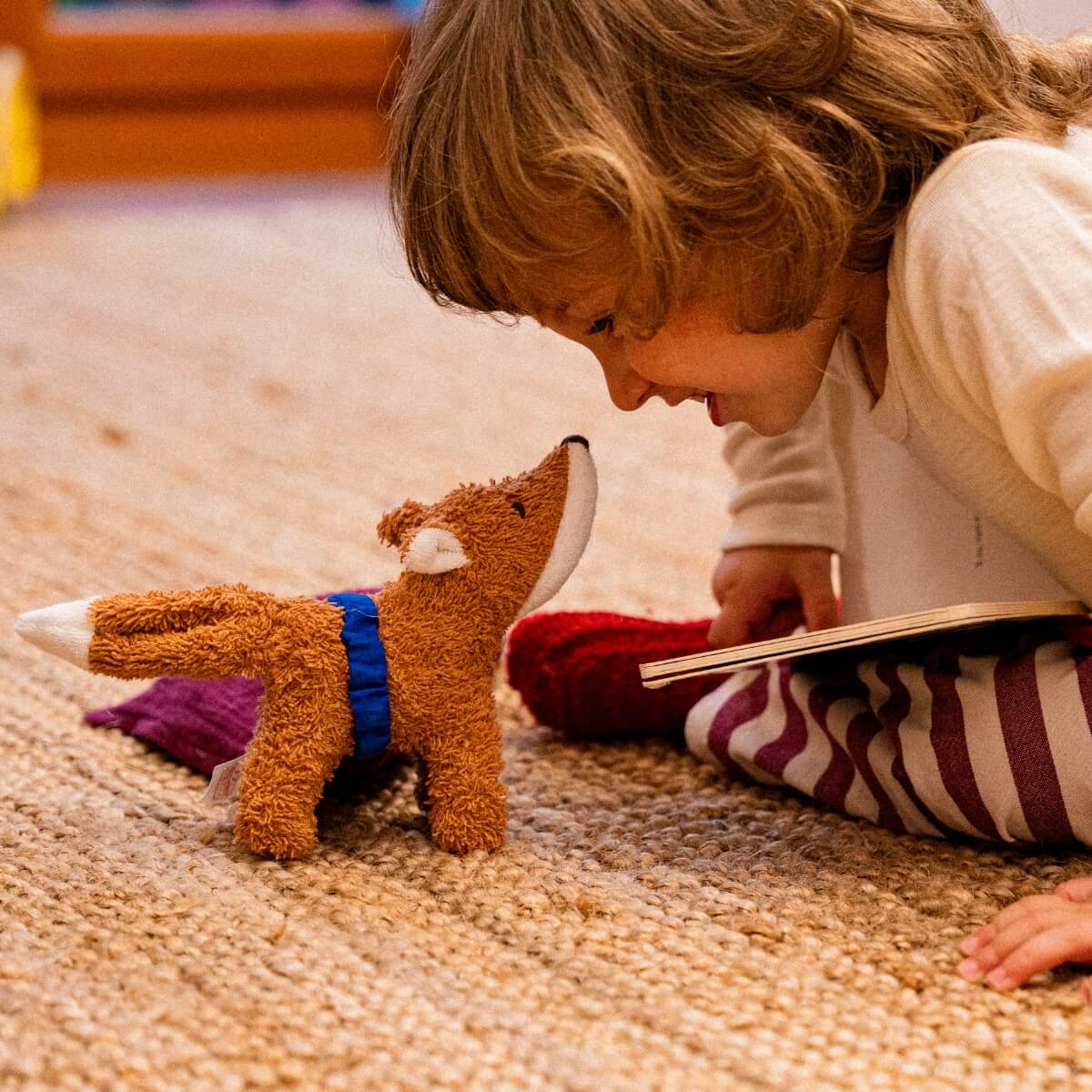 Child enjoying role-play game with Kathe Kruse cuddly fox from Oskar's Wooden Ark in Australia