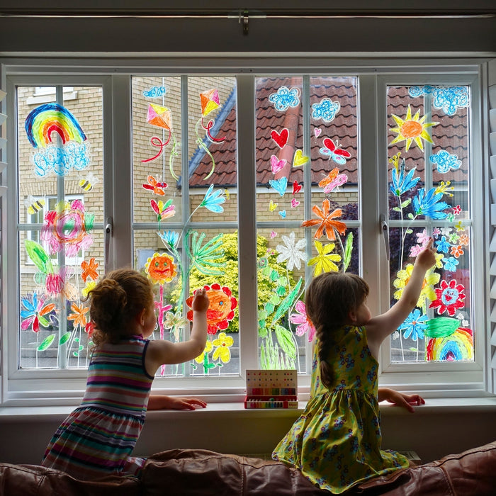 Children drawing on a window using Kitpas removeable rice bran wax crayons from Australia