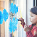 Child drawing on a window using Kitpas removeable rice bran wax crayons from Australia