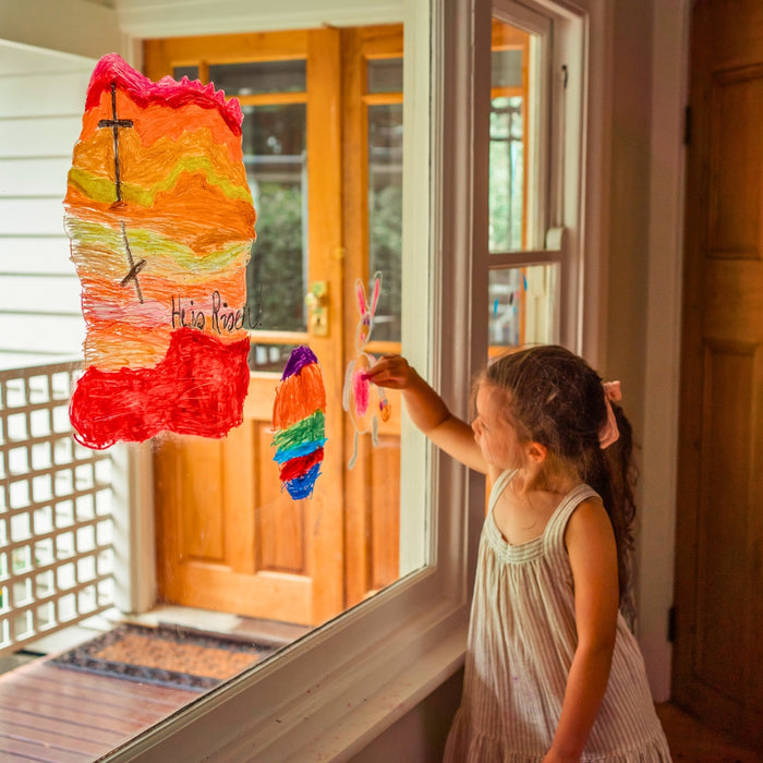 Child drawing on a window using Kitpas removeable rice bran wax crayons from Australia