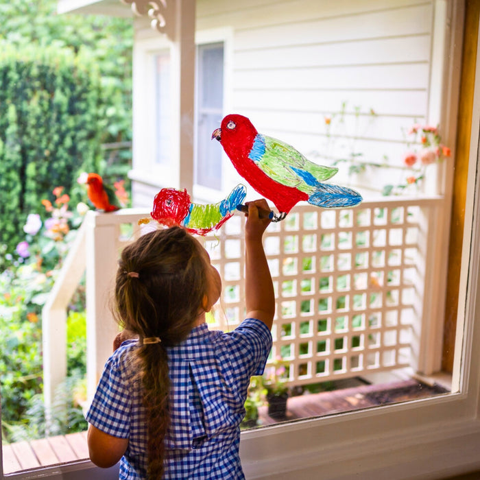 Child drawing on a window using Kitpas removeable rice bran wax crayons from Australia